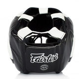 Black boxing headgear with white accents on a white background, featuring the Fairtex brand.
