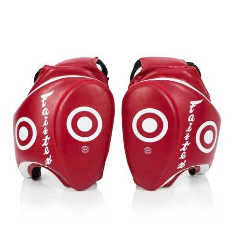 Pair of red protective gear with white circular designs and 'Fairtex' branding on a white background.